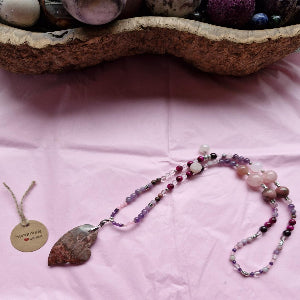Pink semi-precious crystal beads with removable, changeable red agate heart pendant.